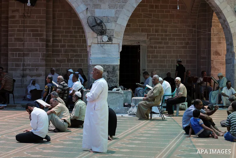 Palestinians Muslims read holy Koran, Islam's holy book, in the Omari Mosque in Gaza City on June 6, 2016, on the first day of the holy month of Ramadan. Muslims around the world refrain from eating, drinking and sexual...