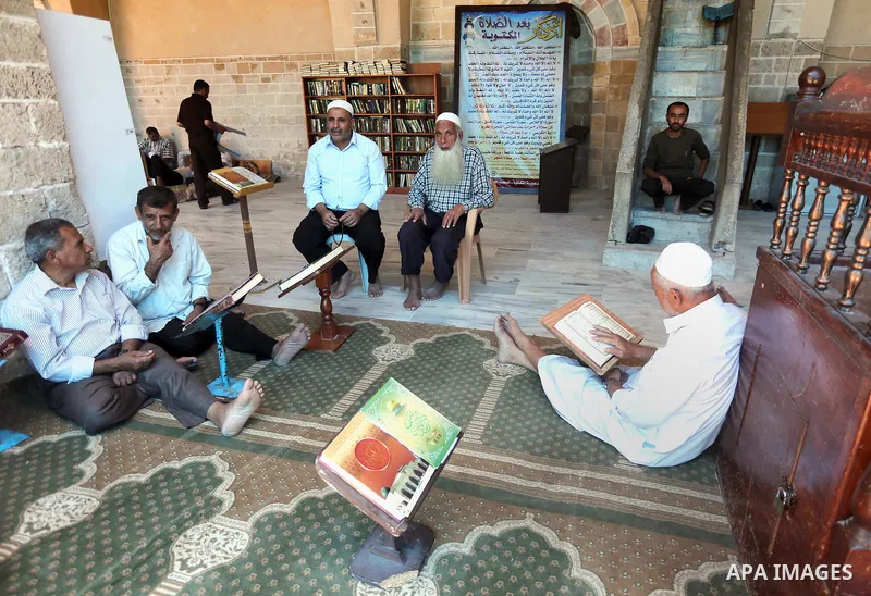 Palestinians Muslims read holy Koran, Islam's holy book, in the Omari Mosque in Gaza City on June 6, 2016, on the first day of the holy month of Ramadan. Muslims around the world refrain from eating, drinking and sexual...
