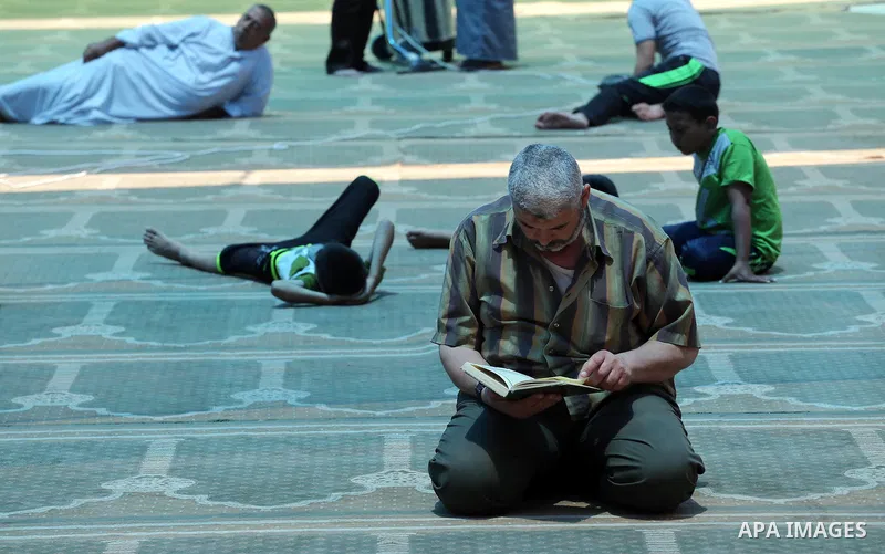 A Palestinian Muslim reads the holy Koran, Islam's holy book, in the Omari Mosque in Gaza City on June 6, 2016, on the first day of the holy month of Ramadan. Muslims around the world refrain from eating, drinking and se...