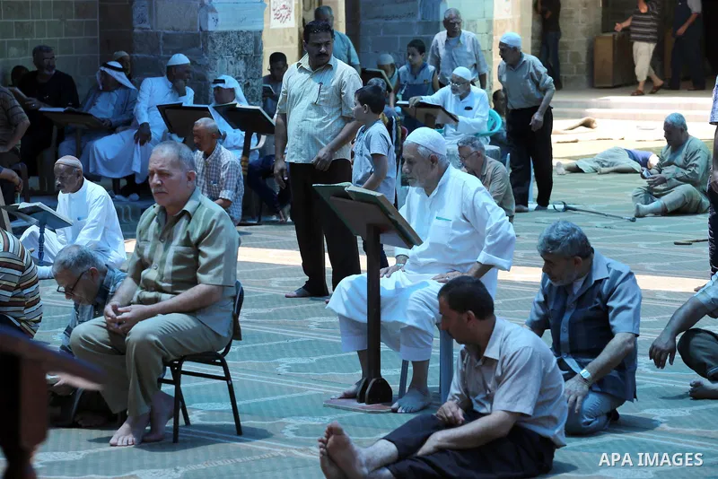 Palestinians Muslims read holy Koran, Islam's holy book, in the Omari Mosque in Gaza City on June 6, 2016, on the first day of the holy month of Ramadan. Muslims around the world refrain from eating, drinking and sexual...