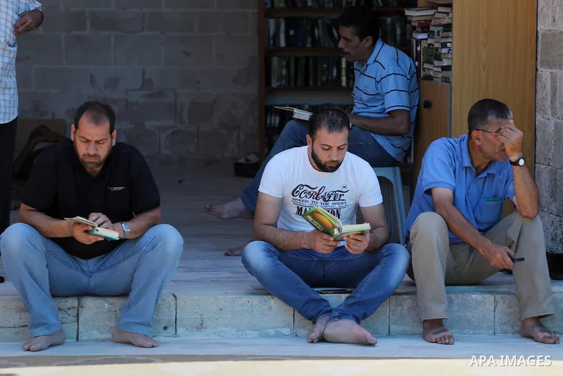 Palestinians Muslims read holy Koran, Islam's holy book, in the Omari Mosque in Gaza City on June 6, 2016, on the first day of the holy month of Ramadan. Muslims around the world refrain from eating, drinking and sexual...