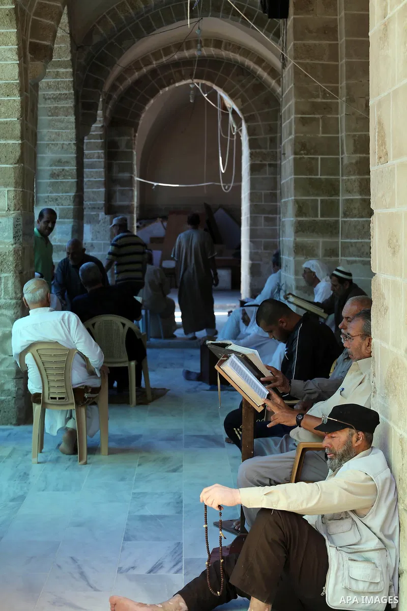 Palestinians Muslims read holy Koran, Islam's holy book, in the Omari Mosque in Gaza City on June 6, 2016, on the first day of the holy month of Ramadan. Muslims around the world refrain from eating, drinking and sexual...