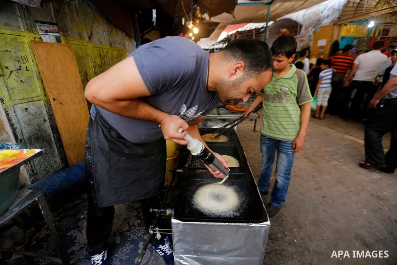Palestinians shop at a market on the first day of the Ramadan, in the Old City of the West Bank town of Hebron, on June 6, 2016 as the faithful prepare to start fasting month of Ramadan. More than 1.5 billion Muslims aro...