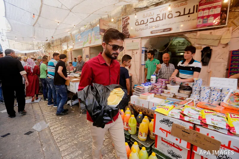 Palestinians shop at a market on the first day of the Ramadan, in the Old City of the West Bank town of Hebron, on June 6, 2016 as the faithful prepare to start fasting month of Ramadan. More than 1.5 billion Muslims aro...