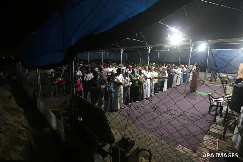 Palestinian Muslim worshipers perform "Taraweeh", nightly prayer of the month of Ramadan, at al-Muntar mosque which was destroyed during the 50-day war between Israel and Hamas militants in the summer of 2014, in Shajaiy...