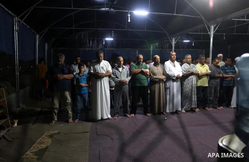 Palestinian Muslim worshipers perform "Taraweeh", nightly prayer of the month of Ramadan, at al-Muntar mosque which was destroyed during the 50-day war between Israel and Hamas militants in the summer of 2014, in Shajaiy...