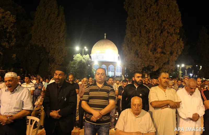 Palestinian Muslim worshipers perform "Taraweeh", nightly prayer of the month of Ramadan, outside the al-Aqsa mosque, in Jerusalem's old city on June 06, 2016 on the first day of the Ramadan. More than 1.5 billion Muslim...