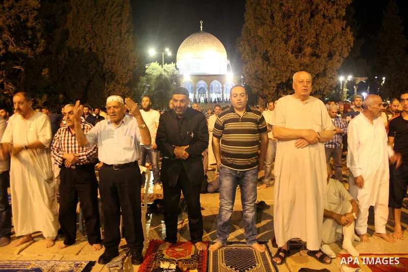 Palestinian Muslim worshipers perform "Taraweeh", nightly prayer of the month of Ramadan, outside the al-Aqsa mosque, in Jerusalem's old city on June 06, 2016 on the first day of the Ramadan. More than 1.5 billion Muslim...