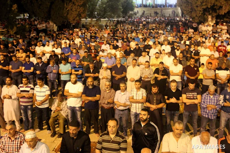 Palestinian Muslim worshipers perform "Taraweeh", nightly prayer of the month of Ramadan, outside the al-Aqsa mosque, in Jerusalem's old city on June 06, 2016 on the first day of the Ramadan. More than 1.5 billion Muslim...