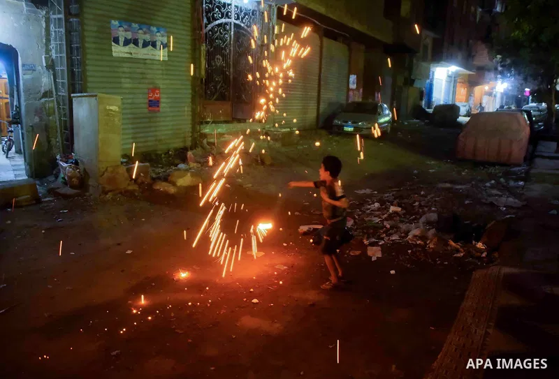 An Egyptian boy plays with fire crackers celebrating ahead of the Muslim holy month of Ramadan in Cairo, Egypt, on June 06, 2016. Ramadan is sacred to Muslims because it is during that month that tradition says the Koran...