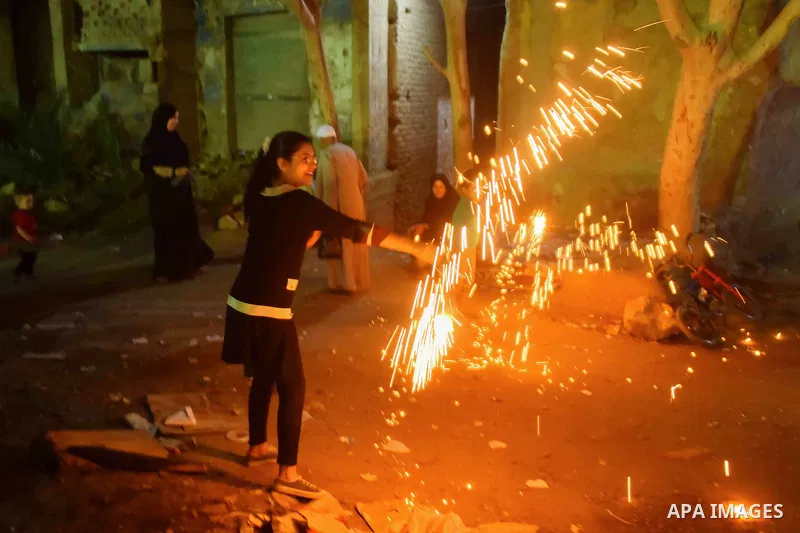 An Egyptian girl plays with fire crackers celebrating ahead of the Muslim holy month of Ramadan in Cairo, Egypt, on June 06, 2016. Ramadan is sacred to Muslims because it is during that month that tradition says the Kora...