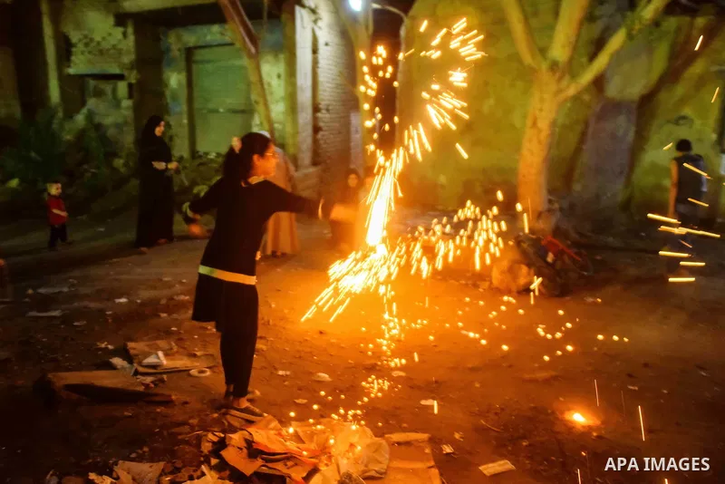 An Egyptian girl plays with fire crackers celebrating ahead of the Muslim holy month of Ramadan in Cairo, Egypt, on June 06, 2016. Ramadan is sacred to Muslims because it is during that month that tradition says the Kora...