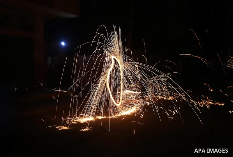 A Palestinian boy plays with fire crackers at street celebrating on the holy month of Ramadan in Gaza city, on June 07, 2016. Ramadan is sacred to Muslims because it is during that month that tradition says the Koran was...
