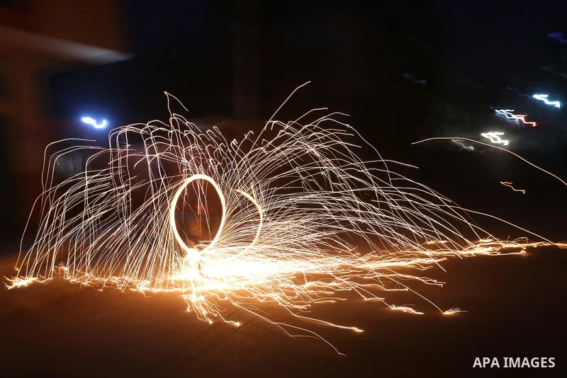 A Palestinian boy plays with fire crackers at street celebrating on the holy month of Ramadan in Gaza city, on June 07, 2016. Ramadan is sacred to Muslims because it is during that month that tradition says the Koran was...