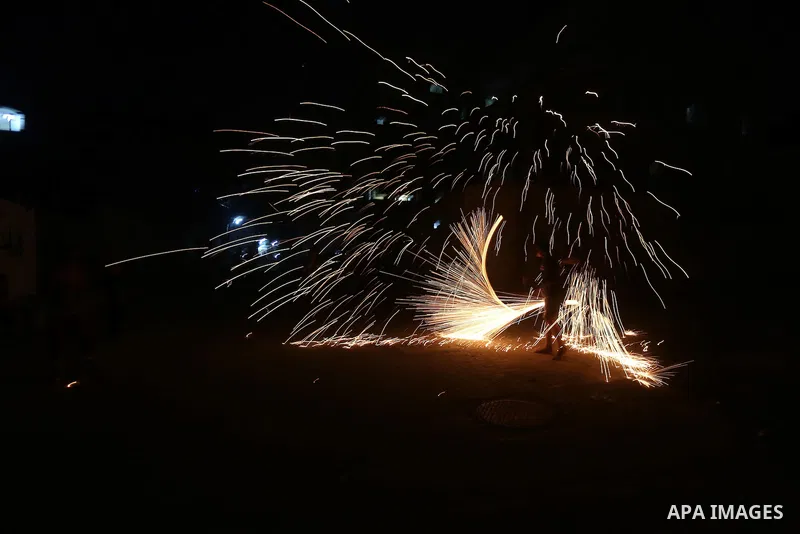 A Palestinian boy plays with fire crackers at street celebrating on the holy month of Ramadan in Gaza city, on June 07, 2016. Ramadan is sacred to Muslims because it is during that month that tradition says the Koran was...