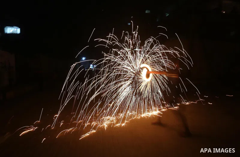 A Palestinian boy plays with fire crackers at street celebrating on the holy month of Ramadan in Gaza city, on June 07, 2016. Ramadan is sacred to Muslims because it is during that month that tradition says the Koran was...