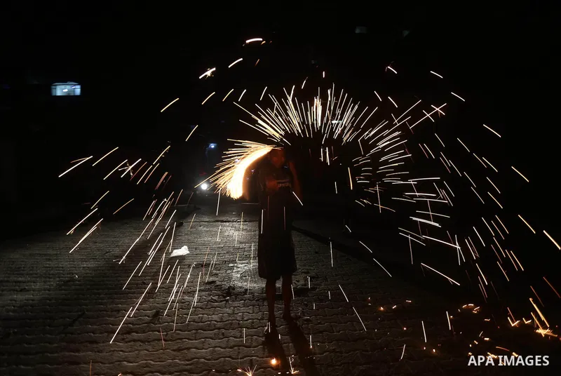A Palestinian boy plays with fire crackers at street celebrating on the holy month of Ramadan in Gaza city, on June 07, 2016. Ramadan is sacred to Muslims because it is during that month that tradition says the Koran was...