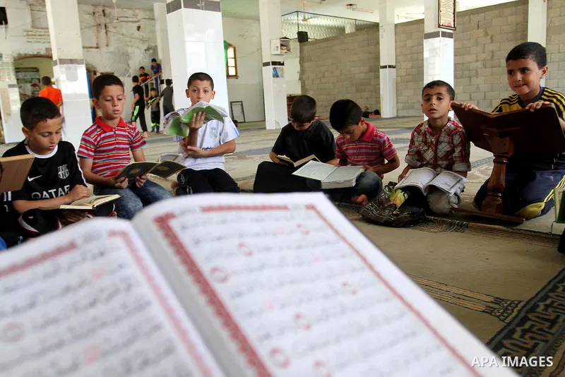 Palestinian boys attend a Quran lesson on the holy month of Ramadan at al-Abrar mosque in Rafah, southern Gaza Strip, on June 07, 2016. Ramadan is sacred to Muslims because it is during that month that tradition says the...