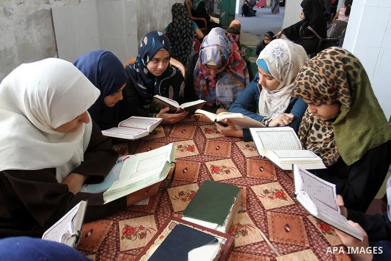 Palestinian girls attend a Quran lesson on the holy month of Ramadan at al-Abrar mosque in Rafah, southern Gaza Strip, on June 07, 2016. Ramadan is sacred to Muslims because it is during that month that tradition says th...