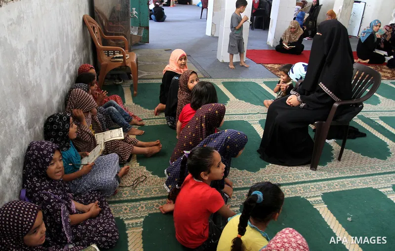 Palestinian girls attend a Quran lesson on the holy month of Ramadan at al-Abrar mosque in Rafah, southern Gaza Strip, on June 07, 2016. Ramadan is sacred to Muslims because it is during that month that tradition says th...