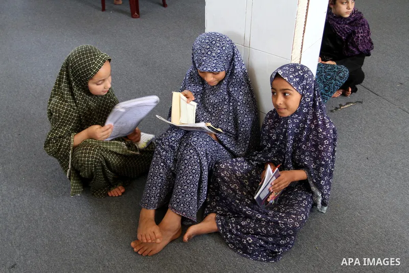 Palestinian girls attend a Quran lesson on the holy month of Ramadan at al-Abrar mosque in Rafah, southern Gaza Strip, on June 07, 2016. Ramadan is sacred to Muslims because it is during that month that tradition says th...