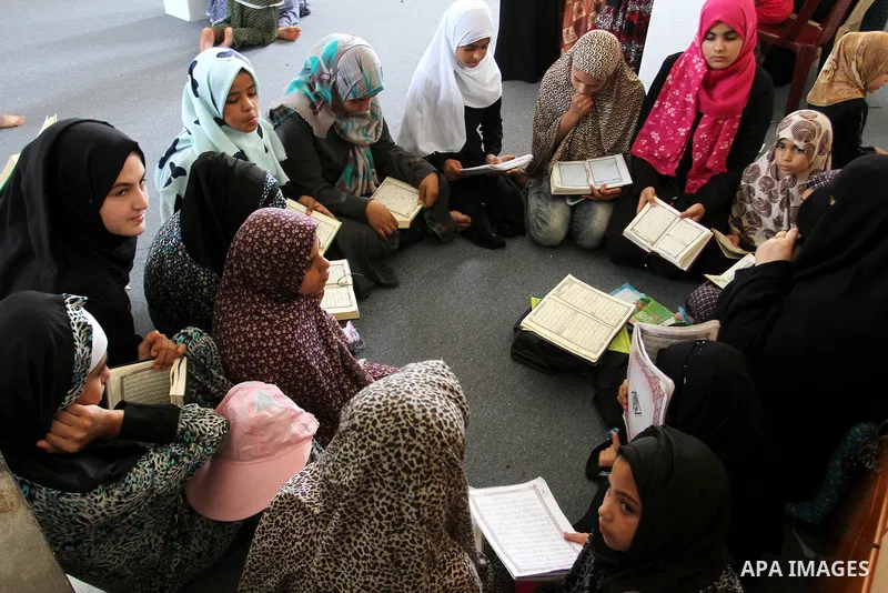 Palestinian girls attend a Quran lesson on the holy month of Ramadan at al-Abrar mosque in Rafah, southern Gaza Strip, on June 07, 2016. Ramadan is sacred to Muslims because it is during that month that tradition says th...