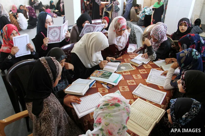 Palestinian girls attend a Quran lesson on the holy month of Ramadan at al-Abrar mosque in Rafah, southern Gaza Strip, on June 07, 2016. Ramadan is sacred to Muslims because it is during that month that tradition says th...