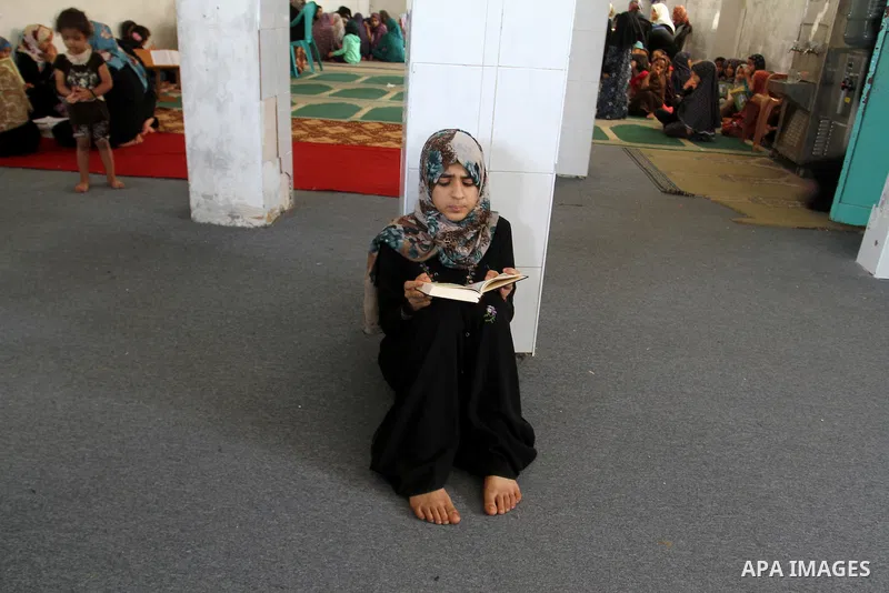 A Palestinian girl attends a Quran lesson on the holy month of Ramadan at al-Abrar mosque in Rafah, southern Gaza Strip, on June 07, 2016. Ramadan is sacred to Muslims because it is during that month that tradition says...