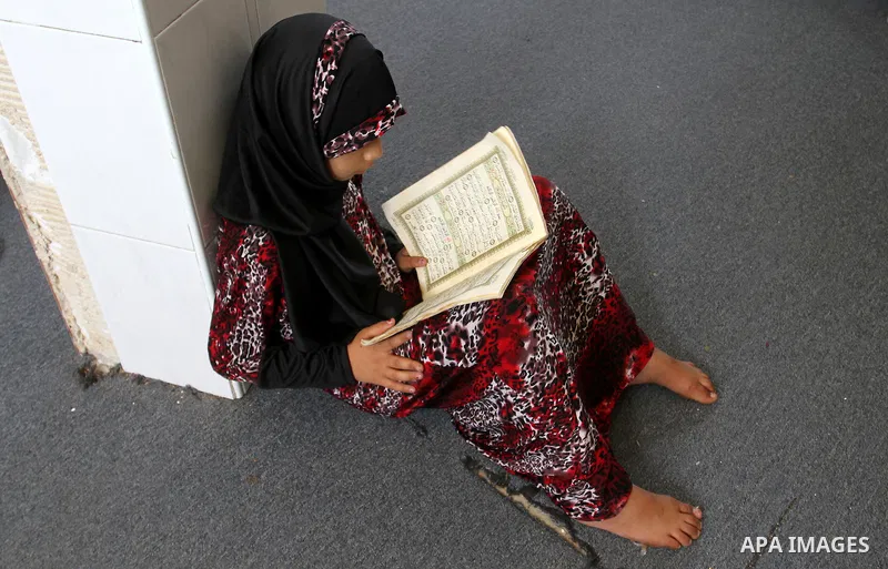 A Palestinian girl attends a Quran lesson on the holy month of Ramadan at al-Abrar mosque in Rafah, southern Gaza Strip, on June 07, 2016. Ramadan is sacred to Muslims because it is during that month that tradition says...