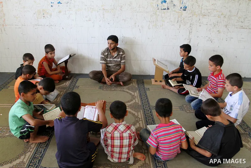Palestinian boys attend a Quran lesson on the holy month of Ramadan at al-Abrar mosque in Rafah, southern Gaza Strip, on June 07, 2016. Ramadan is sacred to Muslims because it is during that month that tradition says the...