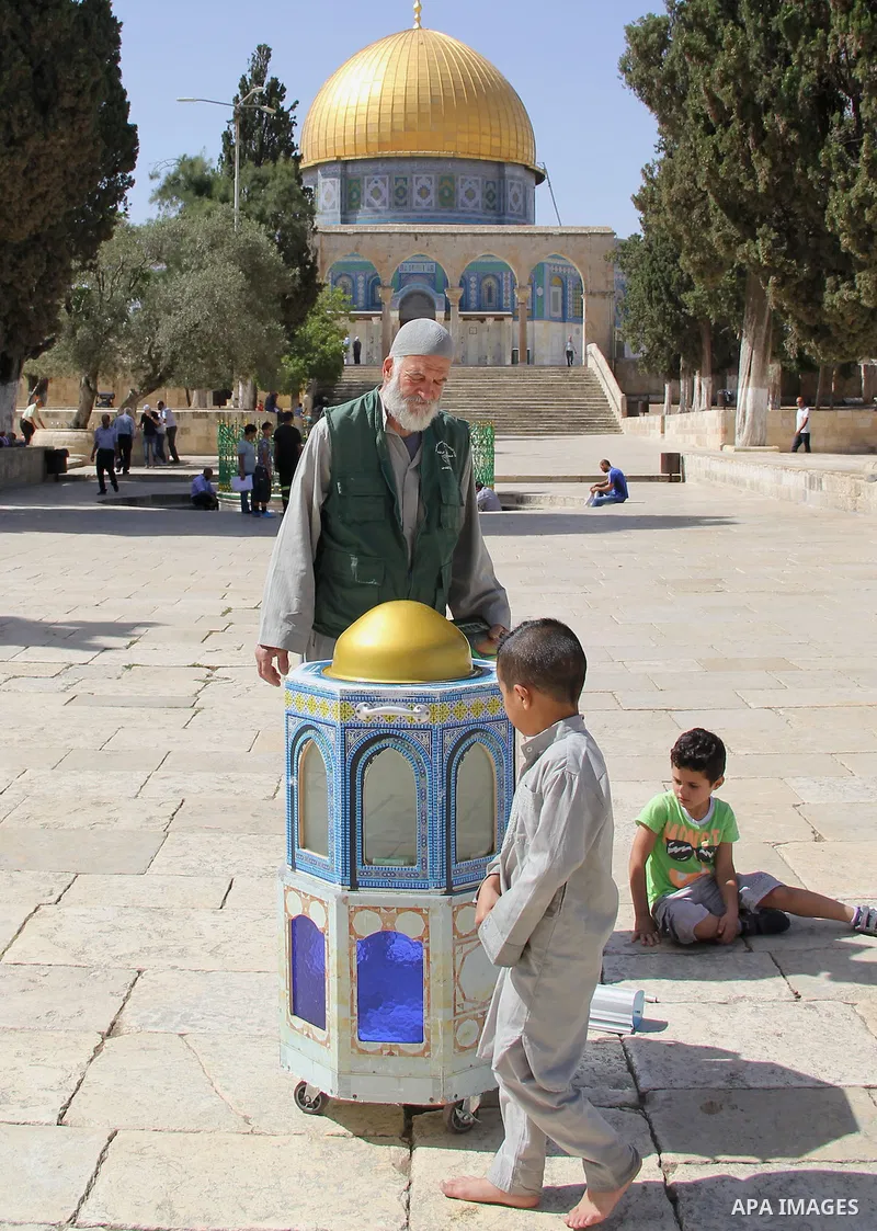 Palestinians Muslims walk walk in front of the Dome of the Rock mosque, in Jerusalem's old city on June 7, 2016. Ramadan is sacred to Muslims because it is during that month that tradition says the Koran was revealed to...