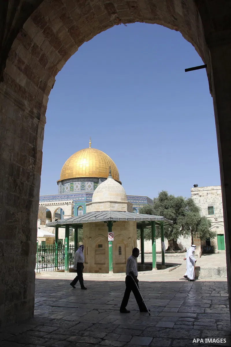 Palestinians Muslims walk walk in front of the Dome of the Rock mosque, in Jerusalem's old city on June 7, 2016. Ramadan is sacred to Muslims because it is during that month that tradition says the Koran was revealed to...