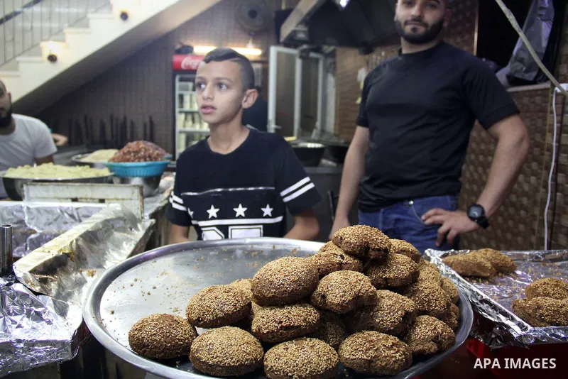 Palestinians shop at a market on the second day of the Ramadan in Jerusalem's old city on June 7, 2016. Ramadan is sacred to Muslims because it is during that month that tradition says the Koran was revealed to the Proph...