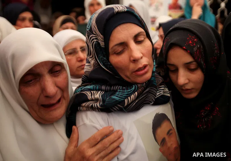 Relatives of Palestinian Jamal Dwikat, who died from wounds he sustained after he was shot during clashes with the Israeli army on Friday, mourn during his funeral in the West Bank village of Balata Albalad near Nablus J...