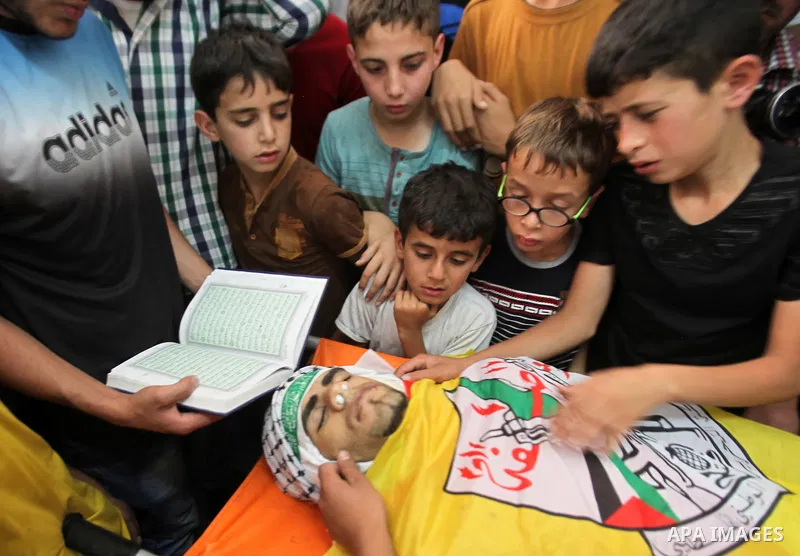Relatives of Palestinian Jamal Dwikat, who died from wounds he sustained after he was shot during clashes with the Israeli army on Friday, mourn during his funeral in the West Bank village of Balata Albalad near Nablus J...