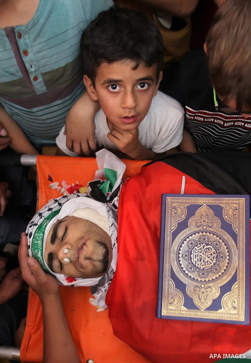 Relatives of Palestinian Jamal Dwikat, who died from wounds he sustained after he was shot during clashes with the Israeli army on Friday, mourn during his funeral in the West Bank village of Balata Albalad near Nablus J...