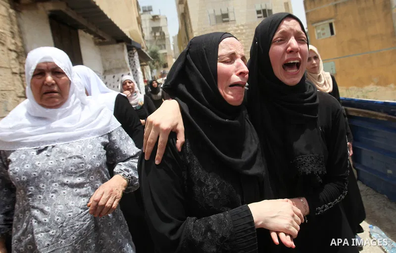 The mother of Palestinian Jamal Dwikat, who died from wounds he sustained after he was shot during clashes with the Israeli army on Friday, mourns during his funeral in the West Bank village of Balata Albalad near Nablus...