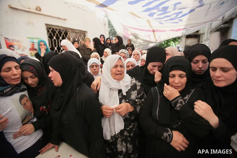 Relatives of Palestinian Jamal Dwikat, who died from wounds he sustained after he was shot during clashes with the Israeli army on Friday, mourn during his funeral in the West Bank village of Balata Albalad near Nablus J...