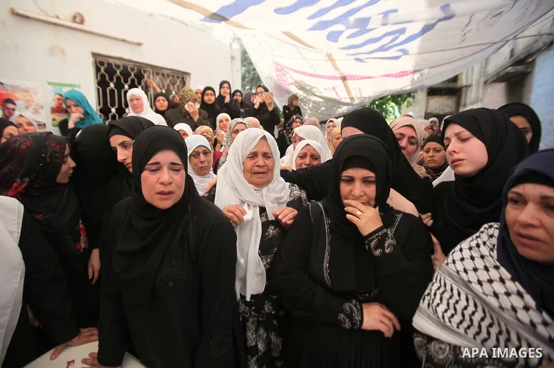 Relatives of Palestinian Jamal Dwikat, who died from wounds he sustained after he was shot during clashes with the Israeli army on Friday, mourn during his funeral in the West Bank village of Balata Albalad near Nablus J...