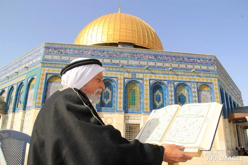A Palestinian man reads holy Koran, Islam's holy book, in front of the Dome of the Rock mosque, in Jerusalem's old city on June 8, 2016. Ramadan is sacred to Muslims because it is during that month that tradition says th...