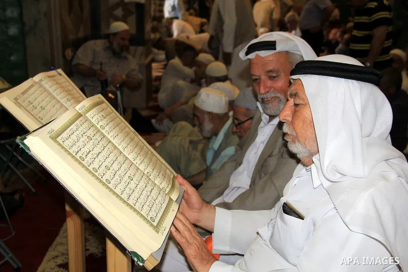 Palestinian men read holy Koran, Islam's holy book, at al-Aqsa mosque, in Jerusalem's old city on June 8, 2016. Ramadan is sacred to Muslims because it is during that month that tradition says the Koran was revealed to t...