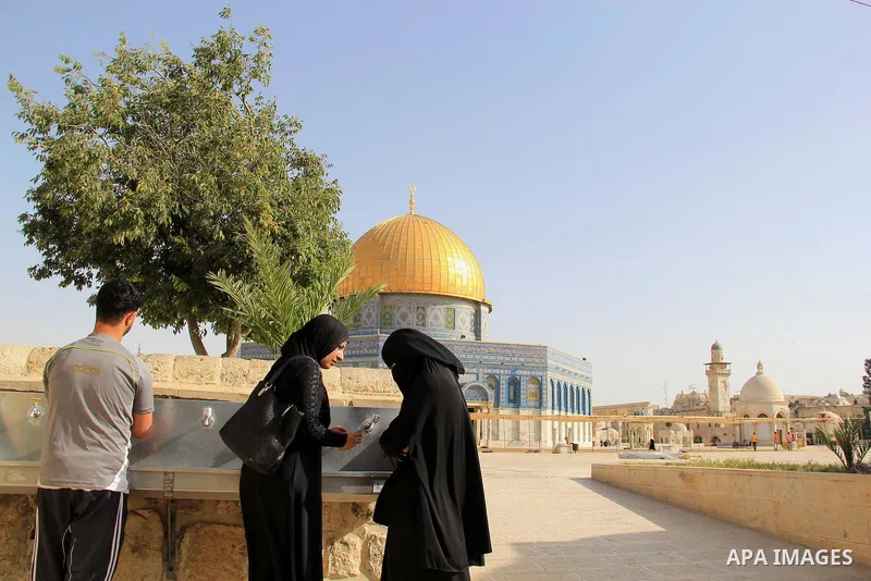 Palestinians Muslims walk walk in front of the Dome of the Rock mosque, in Jerusalem's old city on June 8, 2016. Ramadan is sacred to Muslims because it is during that month that tradition says the Koran was revealed to...