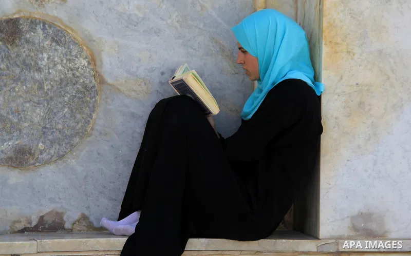 A Palestinian woman reads holy Koran, Islam's holy book, at al-Aqsa mosque, in Jerusalem's old city on June 8, 2016. Ramadan is sacred to Muslims because it is during that month that tradition says the Koran was revealed...