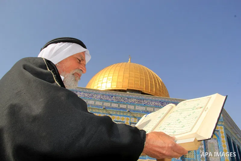 A Palestinian man reads holy Koran, Islam's holy book, in front of the Dome of the Rock mosque, in Jerusalem's old city on June 8, 2016. Ramadan is sacred to Muslims because it is during that month that tradition says th...
