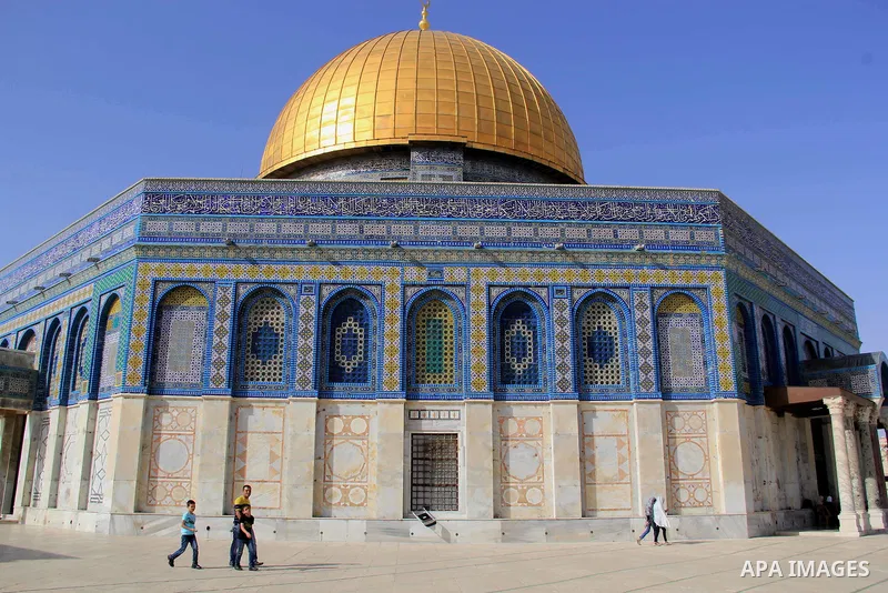 Palestinians Muslims walk walk in front of the Dome of the Rock mosque, in Jerusalem's old city on June 8, 2016. Ramadan is sacred to Muslims because it is during that month that tradition says the Koran was revealed to...