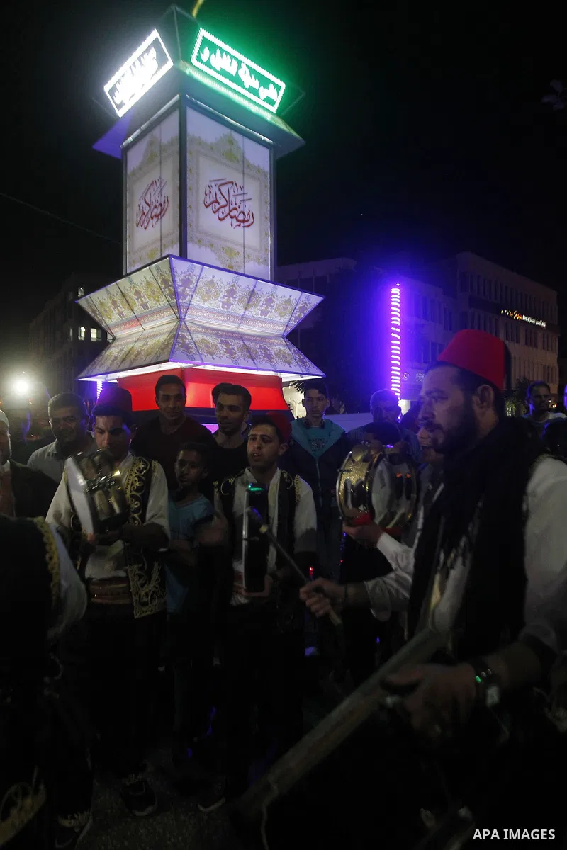 Palestinians take part in a ceremony of lighting Ramadan a traditional lantern known in Arabic as "Fanous", on the holy month of Ramadan in the West bank city of Hebron on June 08, 2016. Ramadan is sacred to Muslims beca...