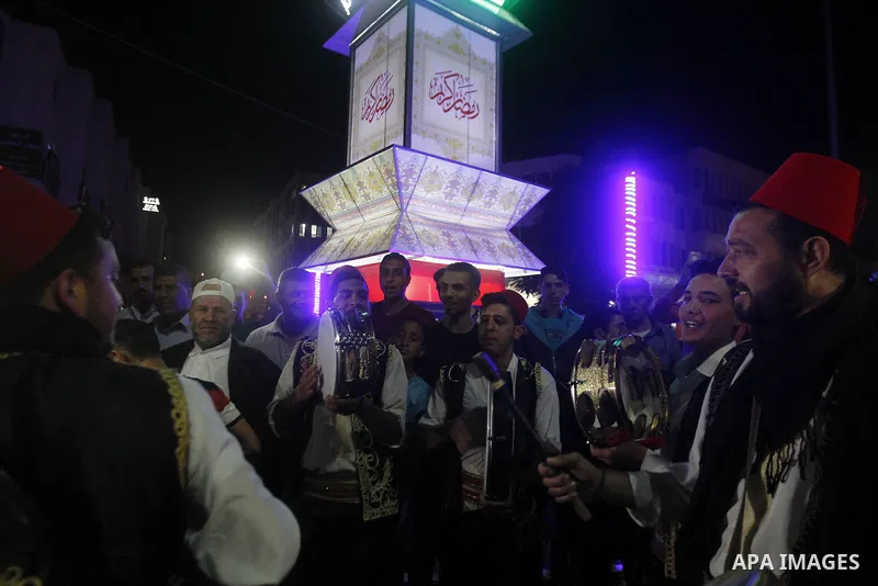 Palestinians take part in a ceremony of lighting Ramadan a traditional lantern known in Arabic as "Fanous", on the holy month of Ramadan in the West bank city of Hebron on June 08, 2016. Ramadan is sacred to Muslims beca...