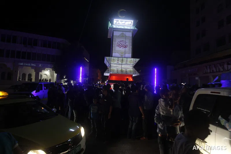 Palestinians take part in a ceremony of lighting Ramadan a traditional lantern known in Arabic as "Fanous", on the holy month of Ramadan in the West bank city of Hebron on June 08, 2016. Ramadan is sacred to Muslims beca...