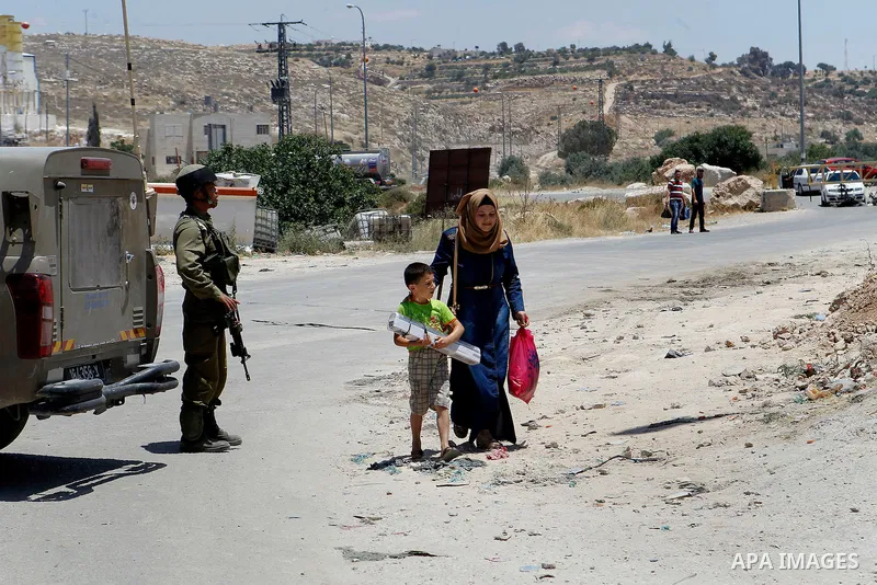 Israeli soldiers stand guard at the entrance of Yatta near the West Bank city of Hebron June 9, 2016. The Israeli army entered the village in search for clues leading to an attack the previous night in the Israeli city o...
