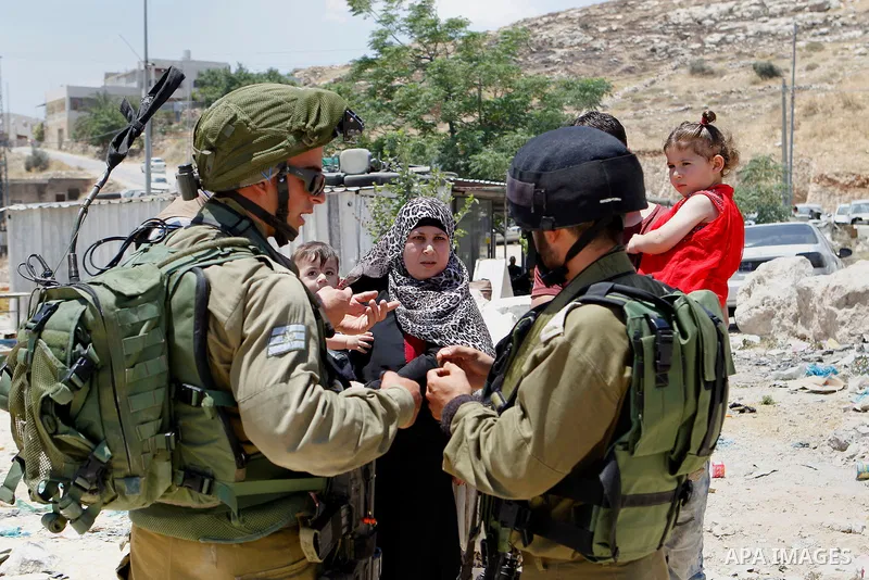 Israeli soldiers stop Palestinians at the entrance of Yatta near the West Bank city of Hebron June 9, 2016. The Israeli army entered the village in search for clues leading to an attack the previous night in the Israeli...